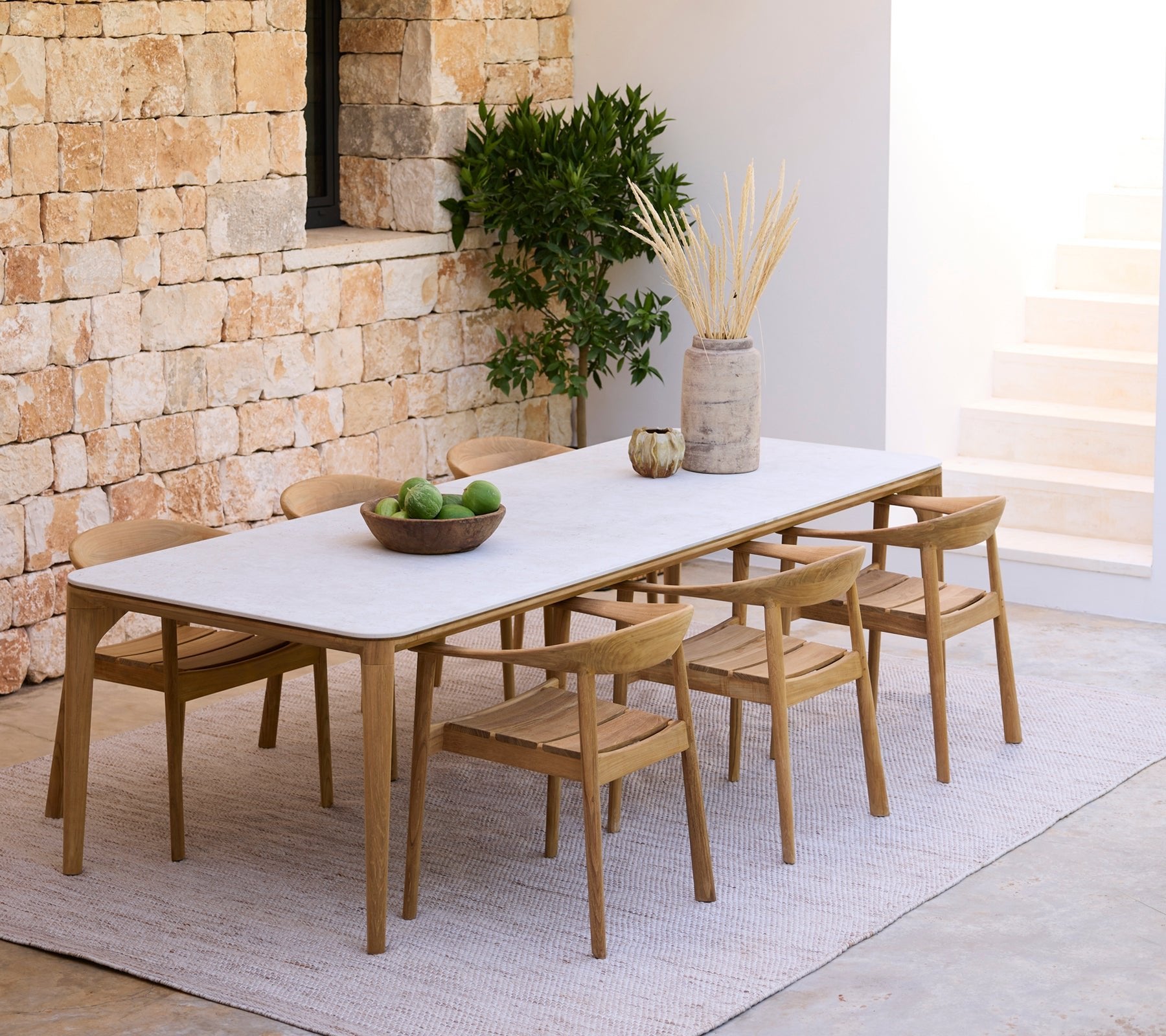Cane-line-miljo-Aspect_dining_table_travetine_look_-_Majestic_chair_-_Cloud_rug_7465_c64d0a87-24f8-4070-acf6-56b386250210